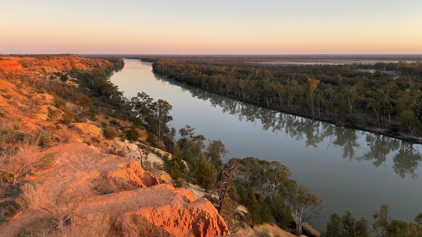 Sunset over a bend in the majestic Murray River at Murtho, with red tall cliffs