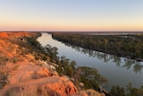 Sunset over a bend in the majestic Murray River at Murtho, with red tall cliffs