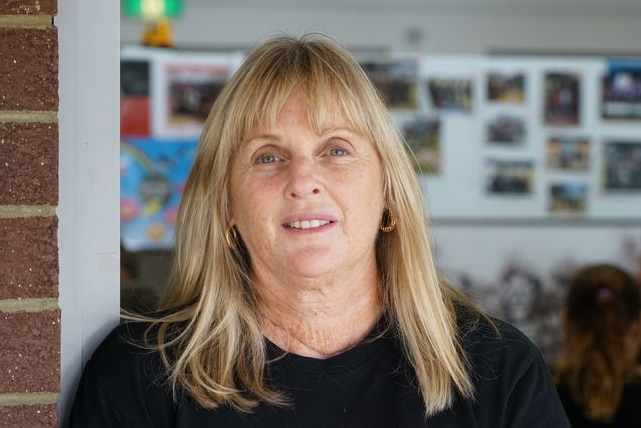 Debbie Kilroy stands at the door of an office.