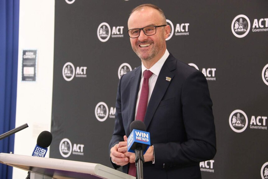 Andrew Barr smiles at a press conference.