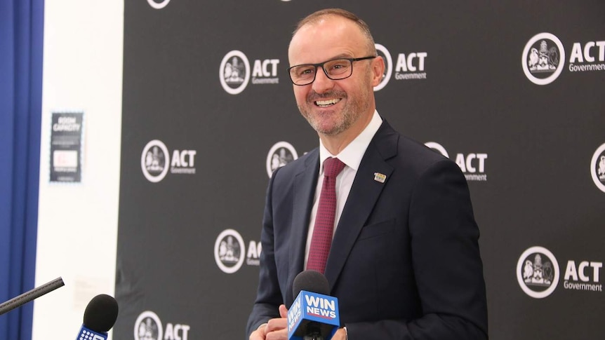 Andrew Barr smiles at a press conference.