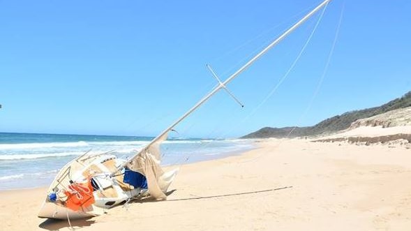 A yacht on its side on a beach