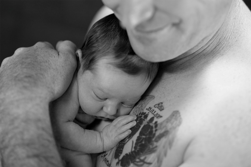 Baby Violet Welsh nestled on her father’s chest with her hand placed on the tattoo Mr Welsh got to honour Ellie.