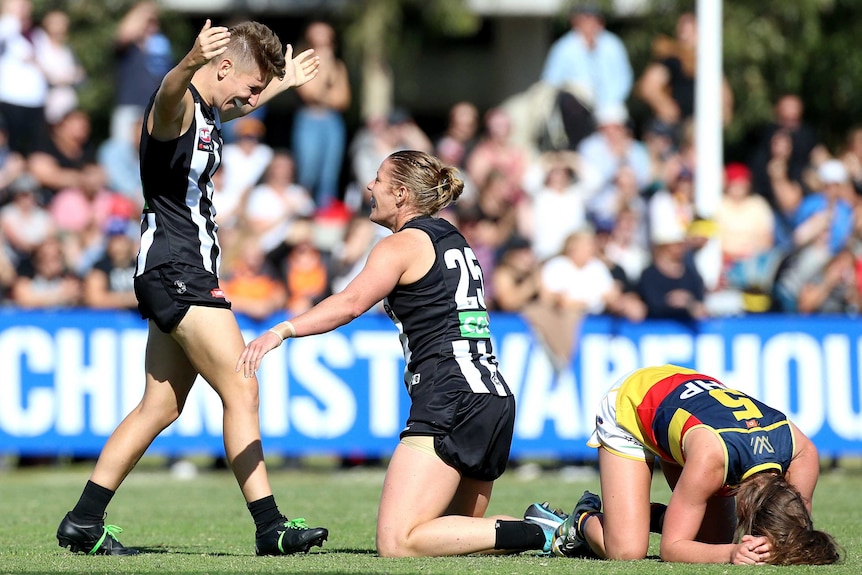 Collingwood players celebrate as Adelaide players despair