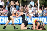 Collingwood players celebrate as Adelaide players despair