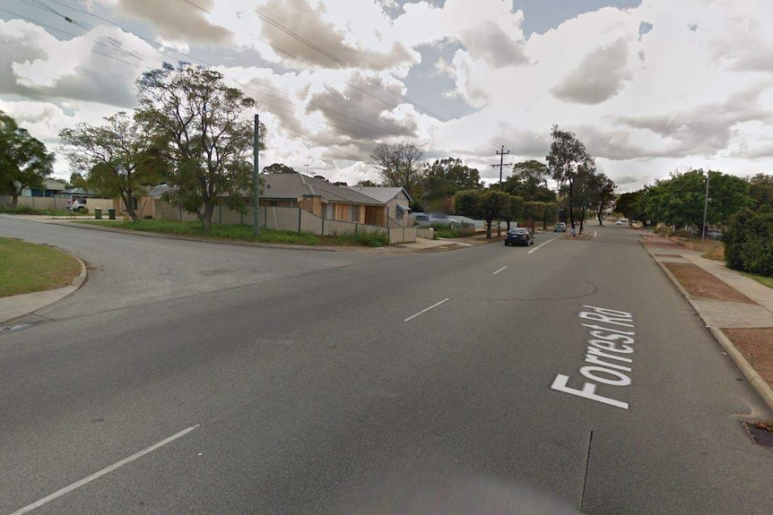 A Google Street View screenshot of a suburban road intersection.