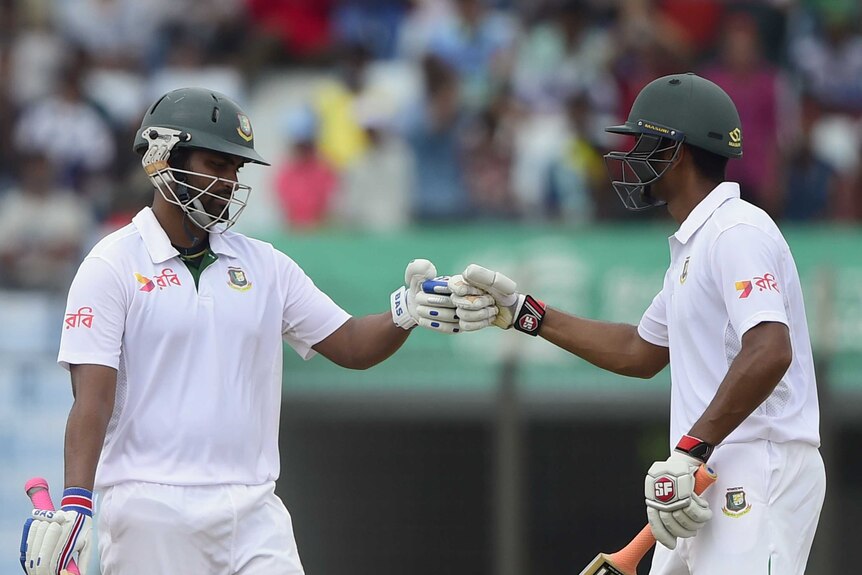 Iqbal and Mahmudullah bump fists on day two of the first Test against South Africa
