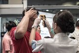 Passengers in Hong Kong have their temperature checked