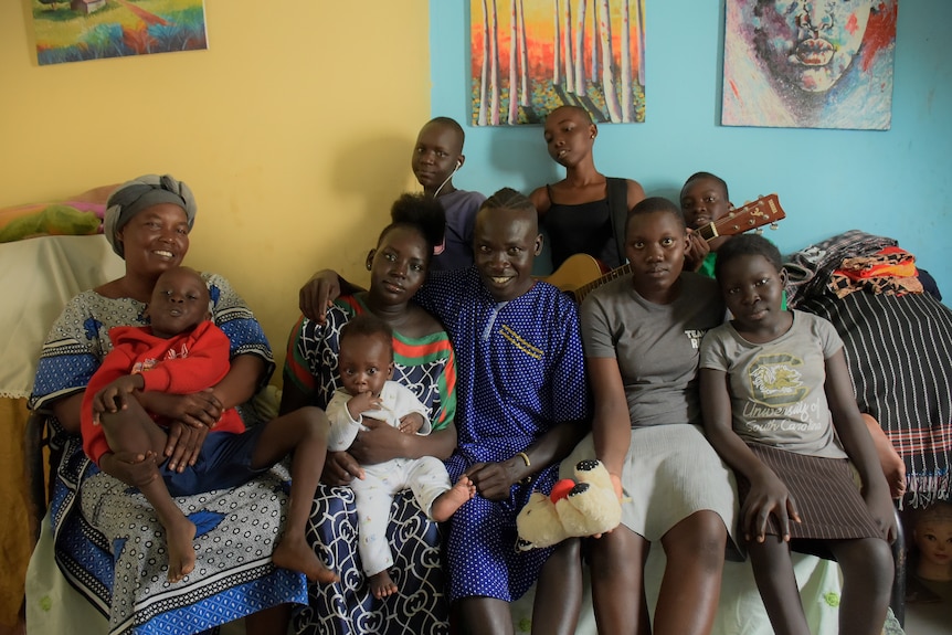 Suleiman Ahmed Abdallh Morgan sits in the centre of his large family on the couch