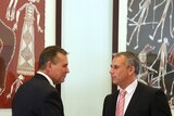 NT Treasurer Dave Tollner (left) shakes the hand of Chief Minister Adam Giles.