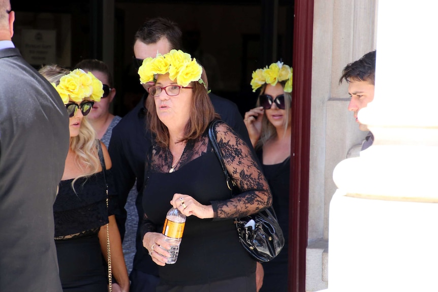 Margaret Dodd and supporters leave the Perth Supreme Court wearing yellow flower crowns.