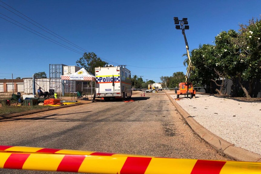 A police truck remains at the scene of a fatal helicopter crash in Broome.