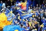 West Coast Eagles fans wave banners and clap during a Western Derby against Fremantle Dockers