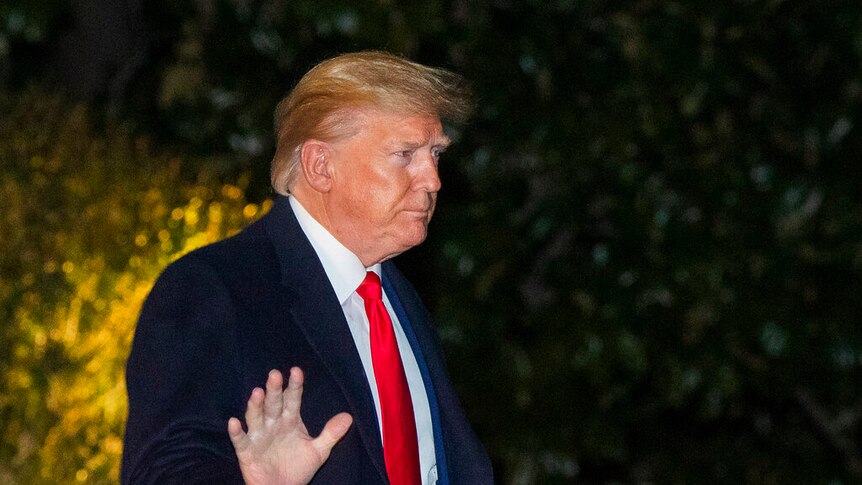President Donald Trump waves as he leaves the White House.