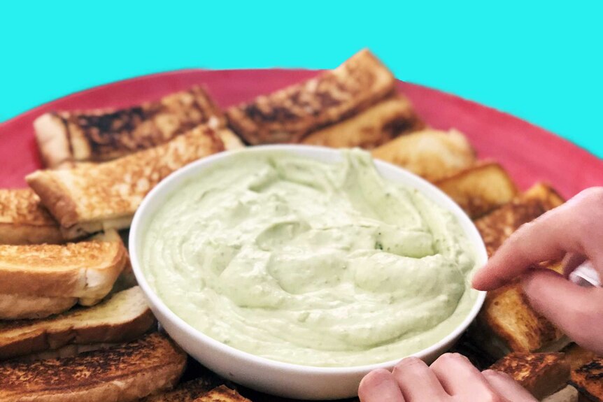 A platter of grilled cheese fingers with a saucer of jalapeno cream in the middle, illustrating our recipe.