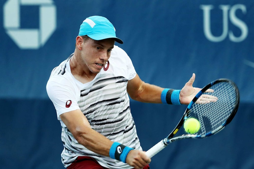 James Duckworth of Australia returns a shot to Robin Haase