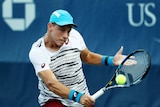 James Duckworth of Australia returns a shot to Robin Haase