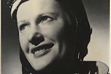 Black and white portrait photo of Nancy Bird Walton in her flight goggles and smiling