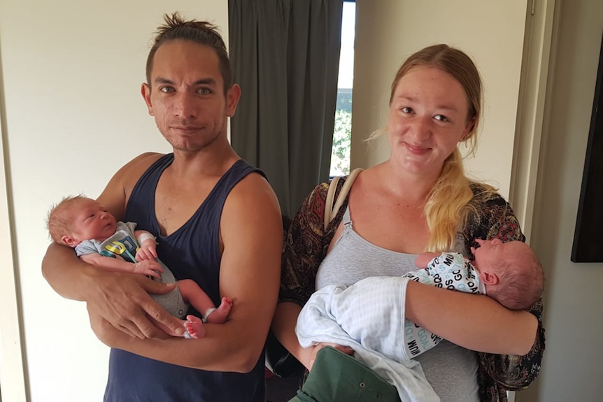 Wayne Godinet and Samantha Stephenson each hold a baby in their arms