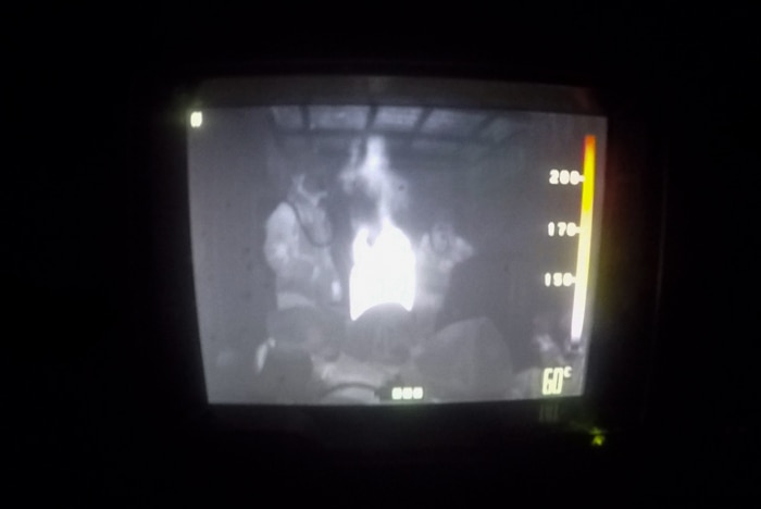A Thermal Imaging Camera display reveals heat and bodies in the dark, smoke-filled room.