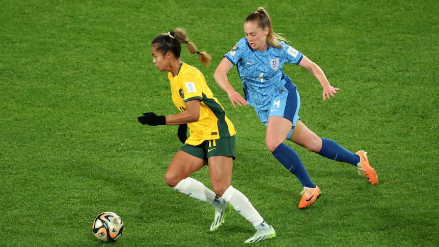 Australia's Mary Fowler, in yellow, battles for possession with England's Keira Walsh, in blue
