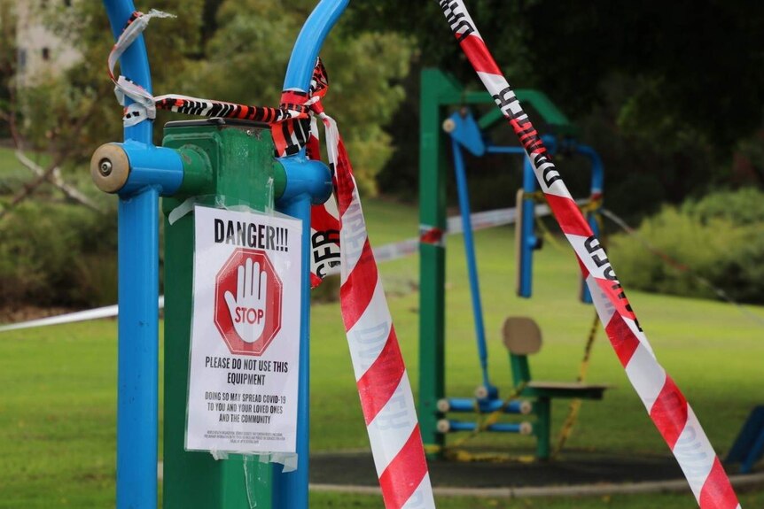 A sign that says "Danger! Do not use this equipment" stuck onto playground equipment