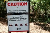 A warning sign at Rapid Creek, which was tested for PFAS run-off from the nearby RAAF Base in Darwin.
