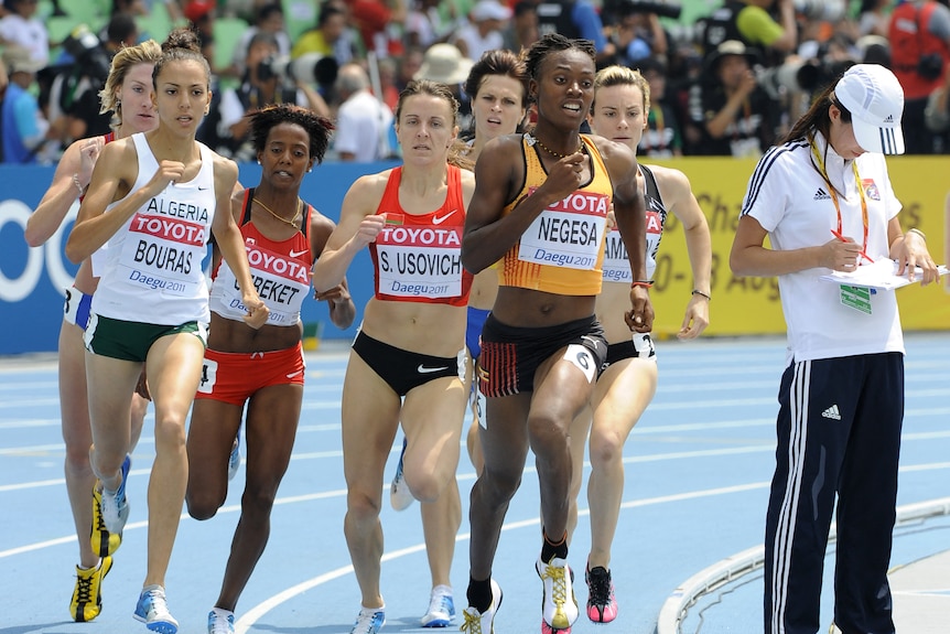 A group of women runners contesting an 800 metre race. 