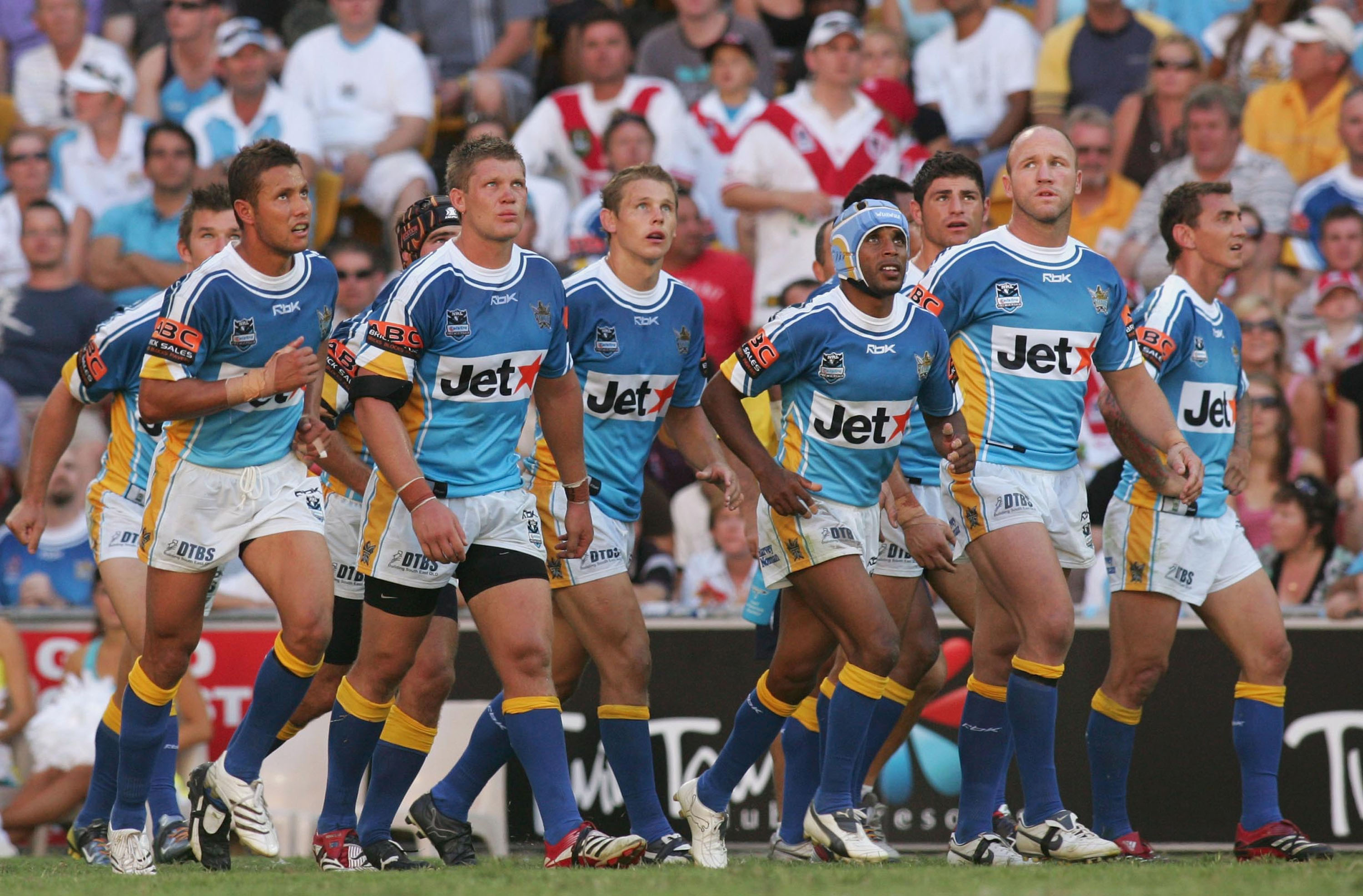 A group of players watch a conversion go over during a rugby league match 