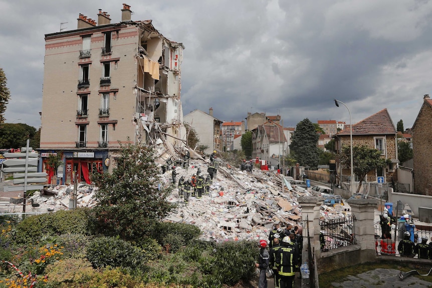 Rescue crews search rubble of collapsed building