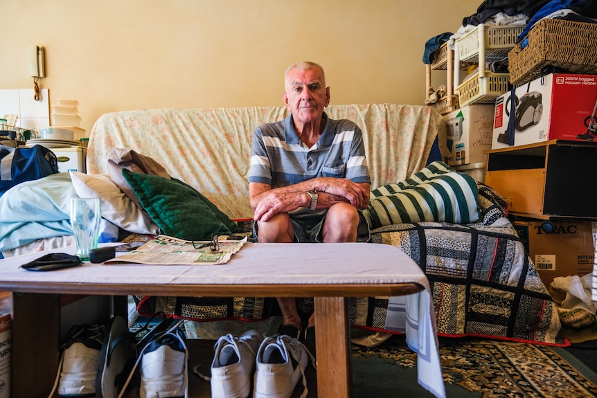 An elderly man sitting on a couch