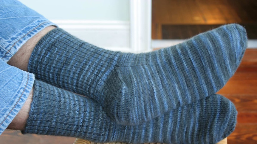 Man wearing blue knitted socks