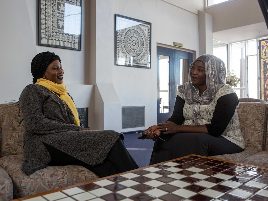 Eglal chats with her friend Fatima during one of the Stand Up group women's meetings in a Dandenong church