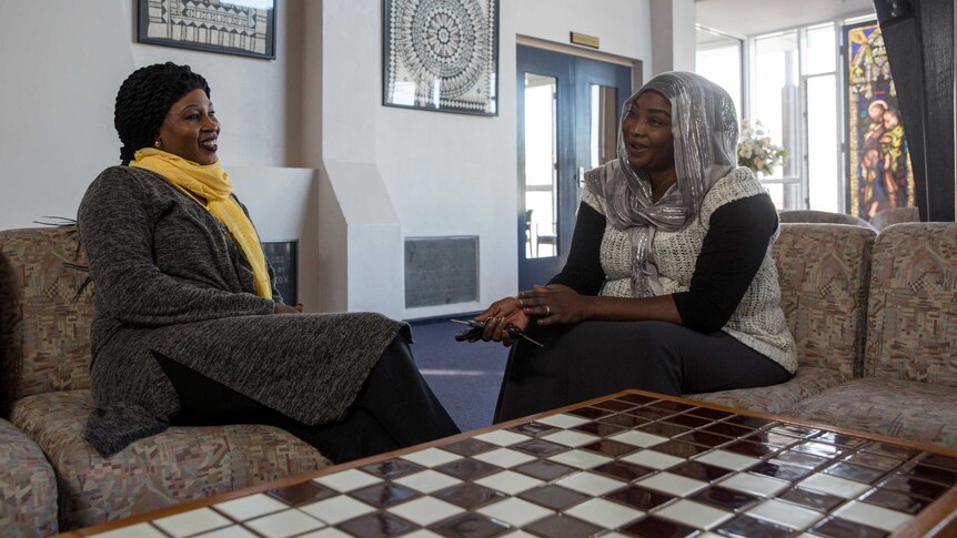 Eglal chats with her friend Fatima during one of the Stand Up group women's meetings in a Dandenong church