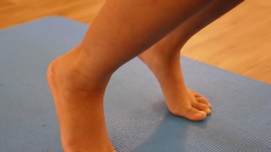 Close up of a child's feet on a yoga mat