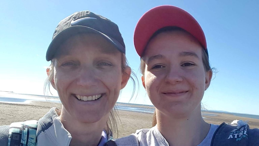 Julie Richards and her daughter Jessica Richards smile in a selfie taken on a beach.