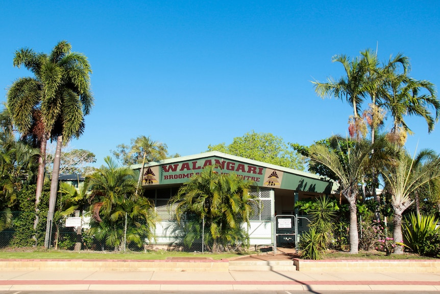 A building with palm trees.