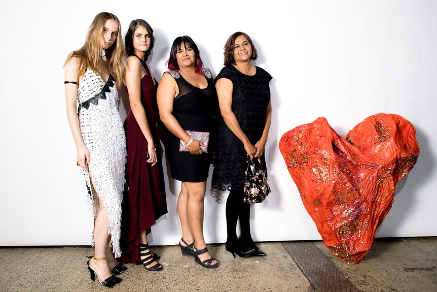 Venessa Harris (second from left) stands with her sister and mother at Sydney's Mercedes-Benz Fashion Week.