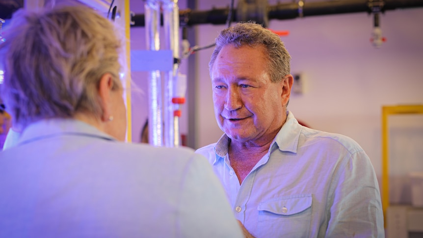 Minderoo Foundation chairman Andrew Forrest stands in the laboratory speaking with visitors.