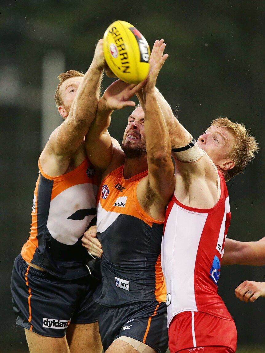 Giant shock ... GWS's Jonathan Giles (L) and Tim Mohr (C) compete with Sydney's Jordan Lockyer.