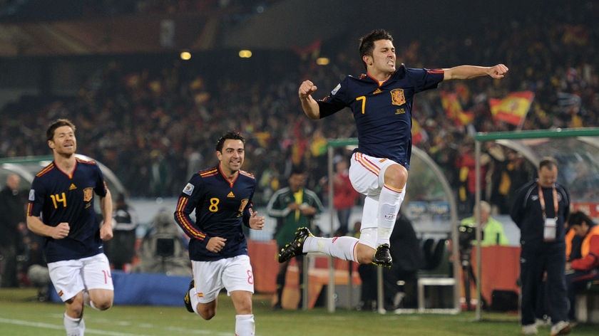 Flying high: David Villa opens the scoring on 24 minutes with his third goal of the tournament.