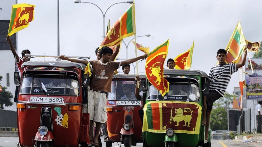 Sri Lankans celebrate their country's military victory over the Tamil Tigers