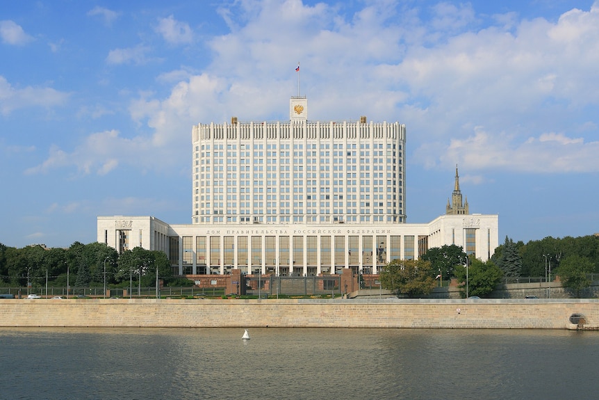 A big white building on a river