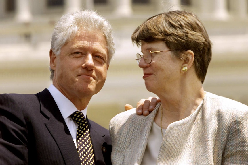 Bill Clinton rests his hand on the shoulder of his attorney-general Janet Reno.