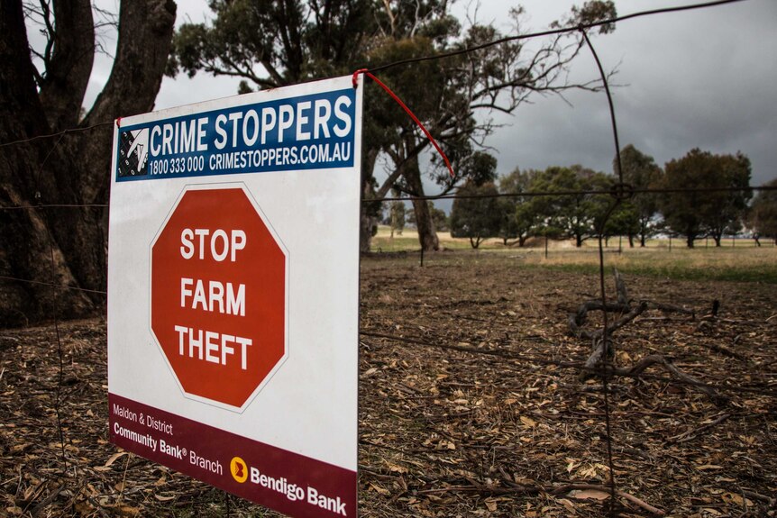 A "Stop Farm Theft" sign on a fence in central Victoria.