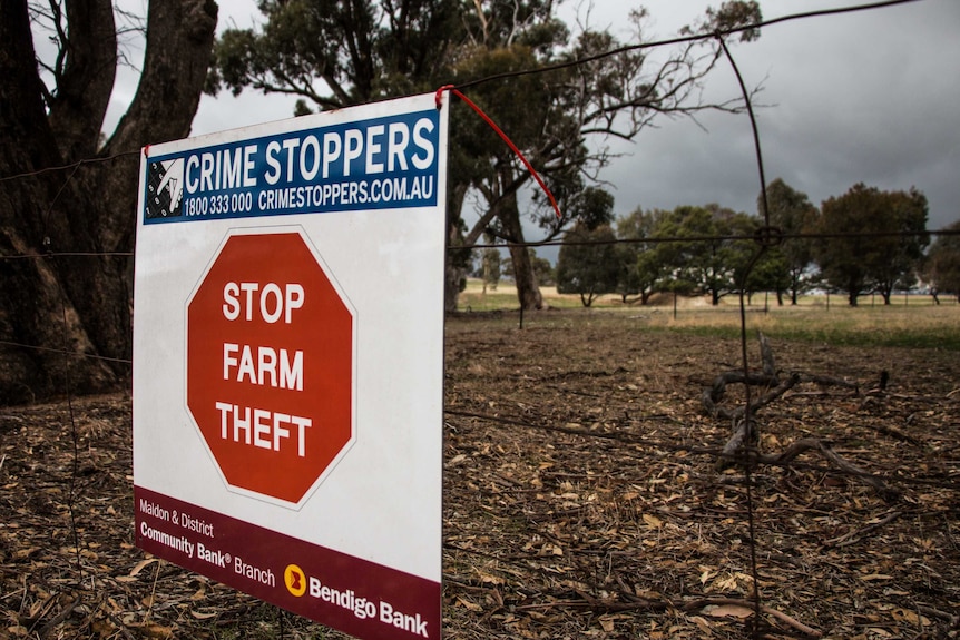 A "Stop Farm Theft" sign on a fence in central Victoria.