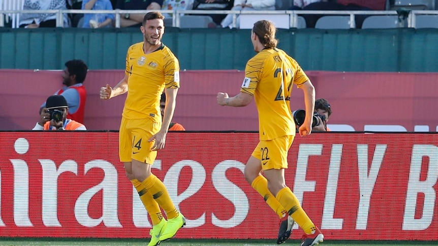 Apostolos Giannou looks towards Jackson Irvine as he celebrates a goal for Australia against Palestine