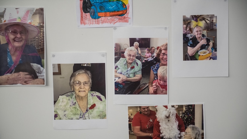 Wall with pictures of Dorothy Major and relatives at her aged care facility.