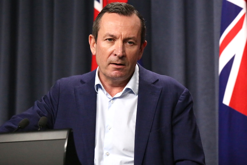 A mid-shot of WA Premier Mark McGowan speaking at a media conference indoors.