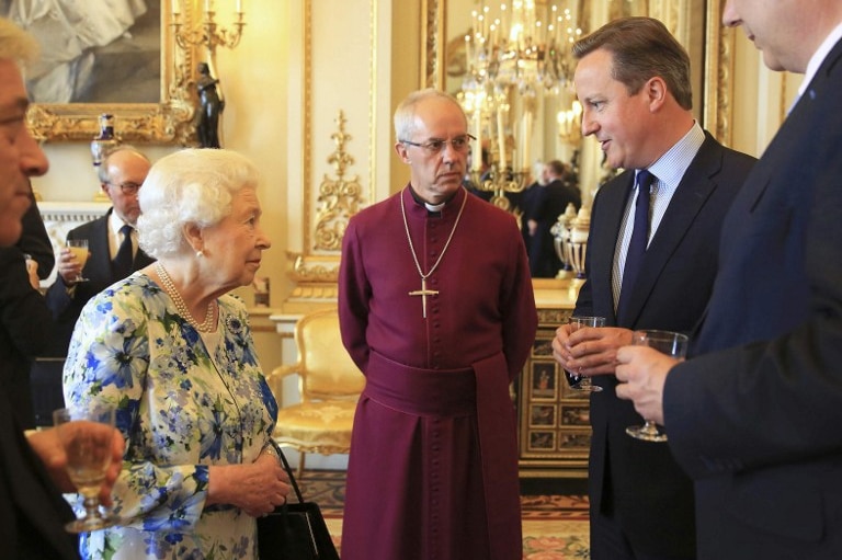Britain's Queen Elizabeth II speaks with British Prime Minister David Cameron (2nd R) during a reception in Buckingham Palace in London on May 10, 2016